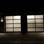 FULL VIEW GARAGE DOOR AT NIGHT INSTALLED BY ONE CLEAR CHOICE GARAGE DOORS